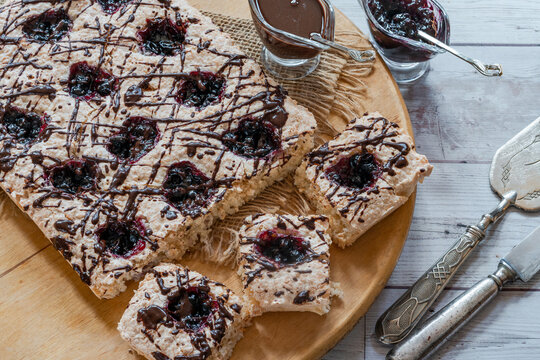 Coconut and blackcurrant jam macaroon traybake with chocolate drizzle