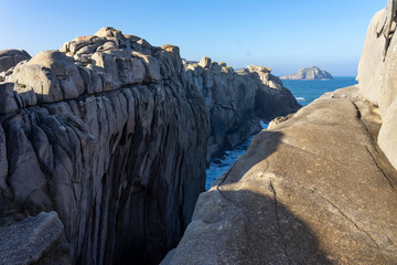Acantilados de papel (Paper cliffs) in the Rías Altas zone in Gaiicia at sunset with sinuous rock formations.