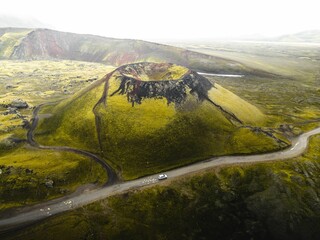 Aerial view of Laki volcano surrounded by greenery hills with road in Iceland © Tomáš Malík/Wirestock Creators