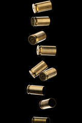 Many Pistol bullet casings isolated on black background