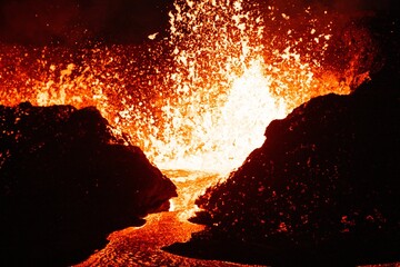 Beautiful shot of lava splashing from a volcano at night in Iceland © Tomáš Malík/Wirestock Creators