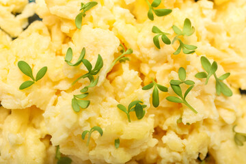 Tasty scrambled eggs as background, closeup