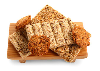 Wooden board with sesame kozinaki on white background
