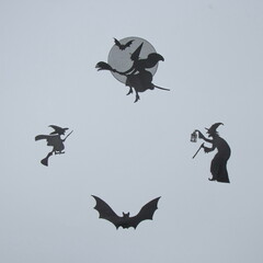Silhouettes of witches and bats for Halloween, on a white background. Minimal aesthetic composition.