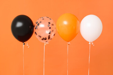 Halloween balloons on orange background