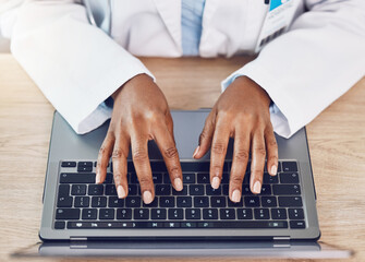 Hands, woman and doctor with laptop working at a desk in a hospital office. Medical expert with...