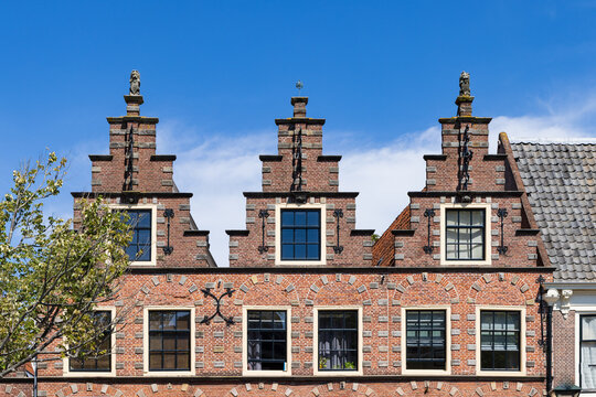 Closeup of three classic step gable houses in a row in Alkmaar in North Holland in The Netherlands.