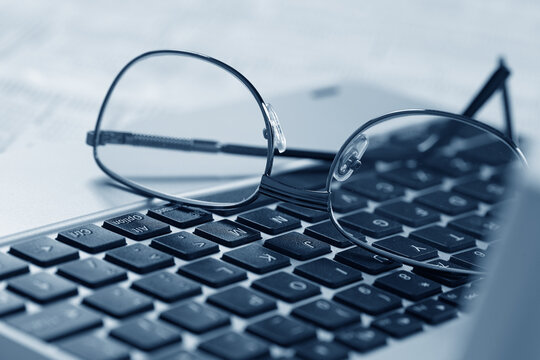 glasses on the laptop keyboard