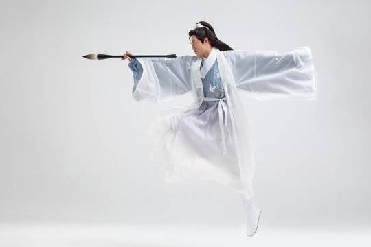 Young Man In Ancient Costume Writing Calligraphy