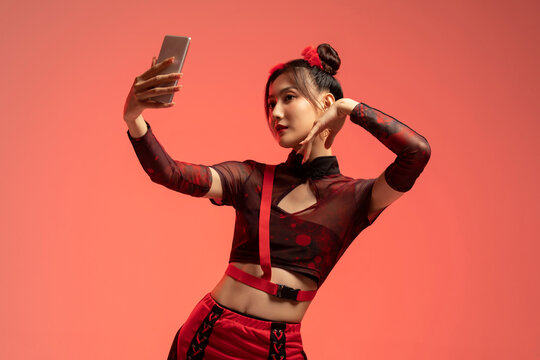 Beautiful young woman taking selfie with smart phone