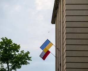 The flag of Poland and Ukraine together on the facade of building. Its a symbol of opposition to Russian aggression, a sign of solidarity and help Ukraine. Copy space