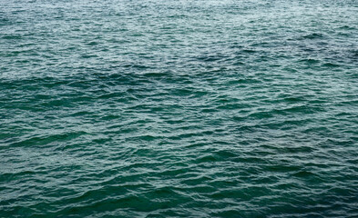 Dark blue sea surface covered with waves.