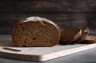 dark rye bread cut on a wooden board