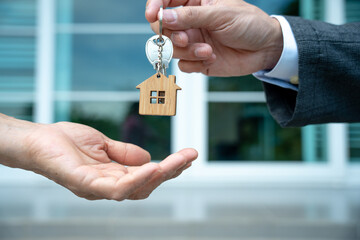 Real estate agent sending the keys to the new homeowner.  buying and selling homes. Mortgage, rent, buy, sell, move in