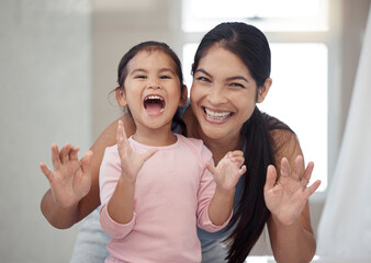 Portrait of mother and child, smile with teeth and morning routine. Asian woman and toddler girl showing clean teeth after brushing it in the bathroom for fun, learning and child development