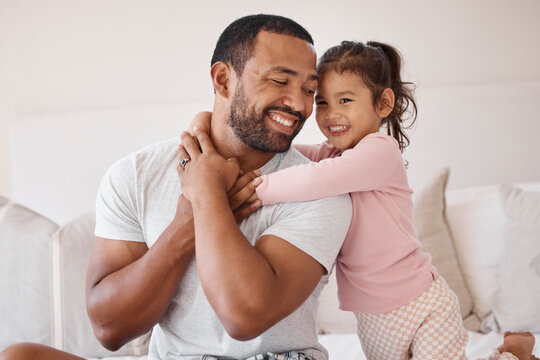 Love, father and family morning hug in bedroom together with child for joyful parent bond in house. Cute embrace from young daughter with smiling dad in a happy home with care, support and trust.