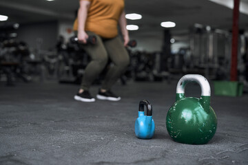 Naklejka na ściany i meble Close up of kettlebell at the floor in the gym