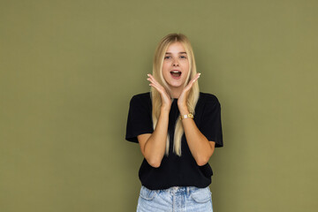 Young shocked surprised astonished woman look camera with opened mouth scream shout isolated on...