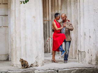 Tango nuevo dance - the famous partner dance with a woman in a red dress with the vibrant & playful...