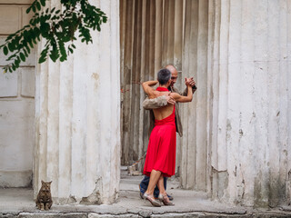 Tango nuevo dance - the famous partner dance with a woman in a red dress with the vibrant & playful...