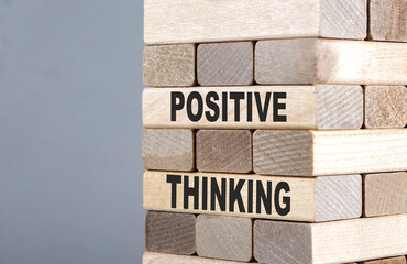 The text on the wooden blocks POSITIVE THINKING