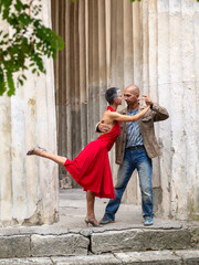 Tango nuevo dance - the famous partner dance with a woman in a red dress with the vibrant & playful...