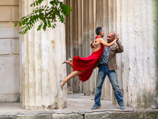 Tango nuevo dance - the famous partner dance with a woman in a red dress with the vibrant & playful...