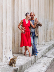 Tango nuevo dance - the famous partner dance with a woman in a red dress with the vibrant & playful style of movement, rich expressions, improvisation and close connection and passion between dancers