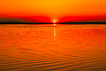 Sunset over the calm lake. sunset or sunrise background photo