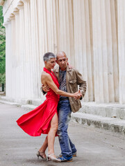 Tango nuevo dance - the famous partner dance with a woman in a red dress with the vibrant & playful...