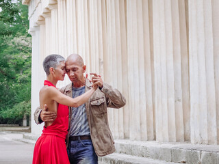 Tango nuevo dance - the famous partner dance with a woman in a red dress with the vibrant & playful...