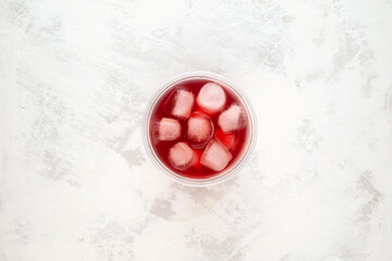 Ovshala lemonade in disposable plastic take away cup, top view. Refreshing summer iced drink. Rose...
