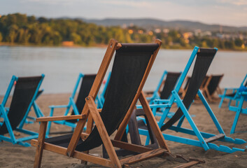 Empty wooden chairs deck chairs by the river at the beach