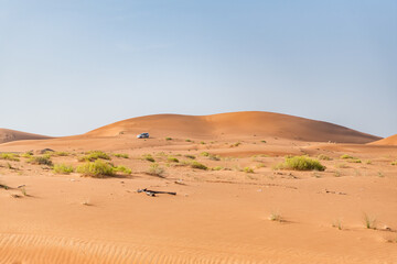 Fototapeta na wymiar Al Ain Desert Dunes with four wheel drive vehicle