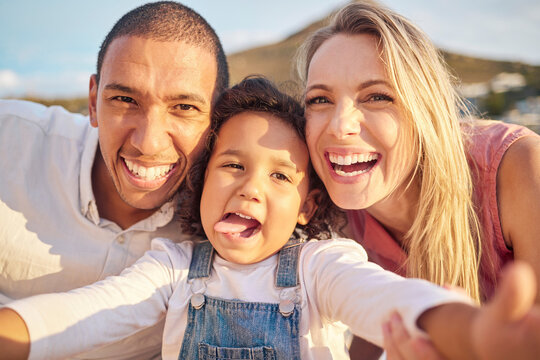Face selfie, comic and funny happy family on a trip, vacation or holiday outdoors. Portrait, love and caring mother, father and child together at beach taking pictures spending free time bonding.