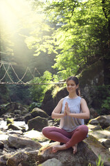 Fototapeta premium Beautiful young woman doing morning exercise in mountains