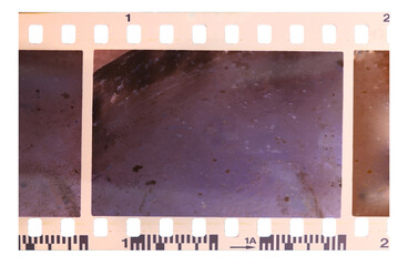Strip of old, worn and bad developed color celluloid film on transparent background