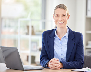 Happy business woman, laptop and smile in success for corporate management at an office desk in the...