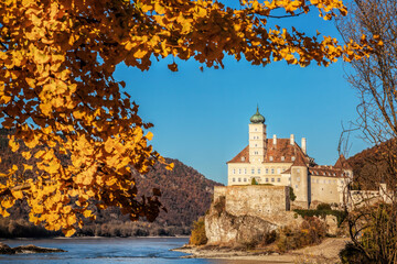 The medieval Schonbuhel castle, built on a rock over Danube river during autumn in Wachau valley,...