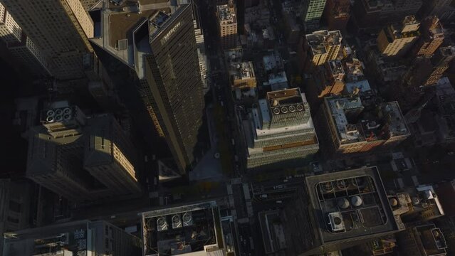 High angle view of tall buildings in city. Tilt down to streets and crossroads with traffic. Manhattan, New York City, USA
