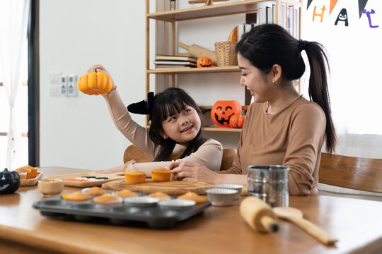 Happy Halloween. Family Mother And Daughter Getting Ready For Holiday And Baking Cookies