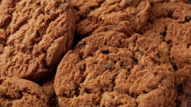 Fresh oatmeal cookies rotating. Food concept. Homemade cookies with chocolate. Stack of whole meal cookies. Close-up in 4K, UHD