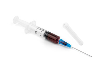 A syringe with blood for a blood test. Medical syringe with dark liquid. Drugs. Vitamins. Medicines.