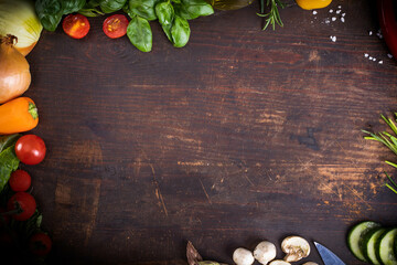Fresh raw vegetable, herbs, on a rustic wood board. Healthy cooking composition, food frame, background with copy space.