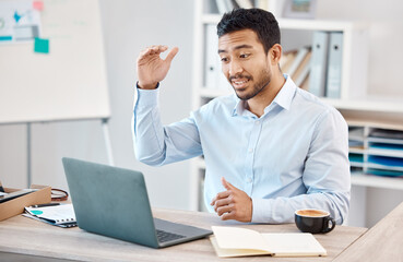 Man with laptop at desk on video call for work, via web in office with coffee and gesture with hand. Young man at table in home office, with computer on the internet for business call or webinar.