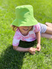 Close-up of a summer portrait of a girl in a green hat