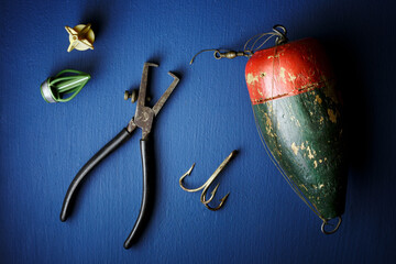 Fishing tackle still life with a top view on a blue background fine art.
