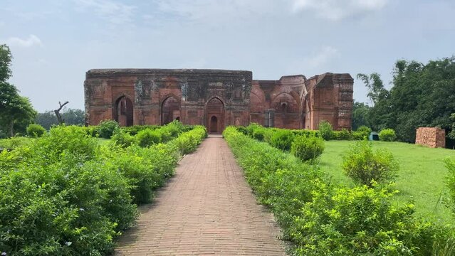 Cinematic shot of Tantipara Mosque at Gaur in Malda District in West Bengal. The mosque has an oblong structure made of bricks with two aisles of stone columns.