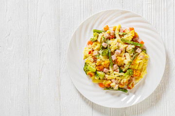 Ham and Noodle Casserole on white plate, top view