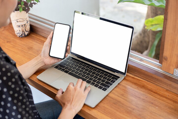 computer screen,cell phone blank mockup.hand woman work using laptop texting mobile.white background for advertising,contact business search information on desk in cafe.marketing,design